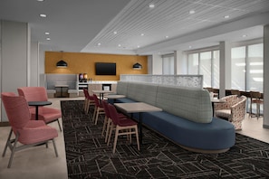 A modern hotel lobby with a seating area, a bar, and a television. - Home2 Suites By Hilton El Paso East Loop 375 (El Paso)