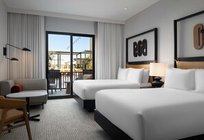 A hotel room with two beds, a sofa, a small table, and a view of the outside. - The Ava Hotel Paso Robles, Curio Collection By Hilton (Paso Robles)