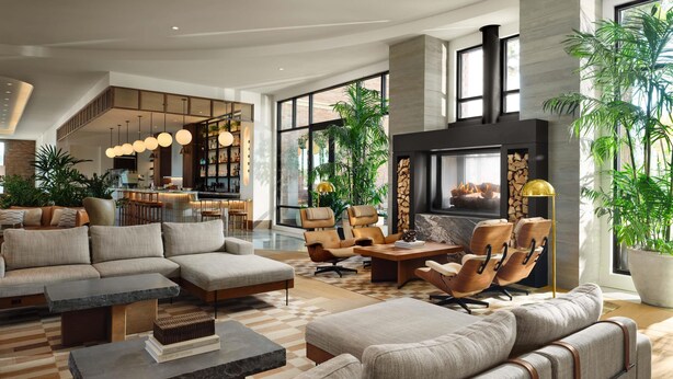 A spacious living area with a fireplace, comfortable seating, and large windows. - The Ava Hotel Paso Robles, Curio Collection By Hilton (Paso Robles)