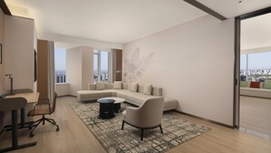 Een moderne woonkamer met een modulaire bank, een salontafel en een bureau met een stoel.