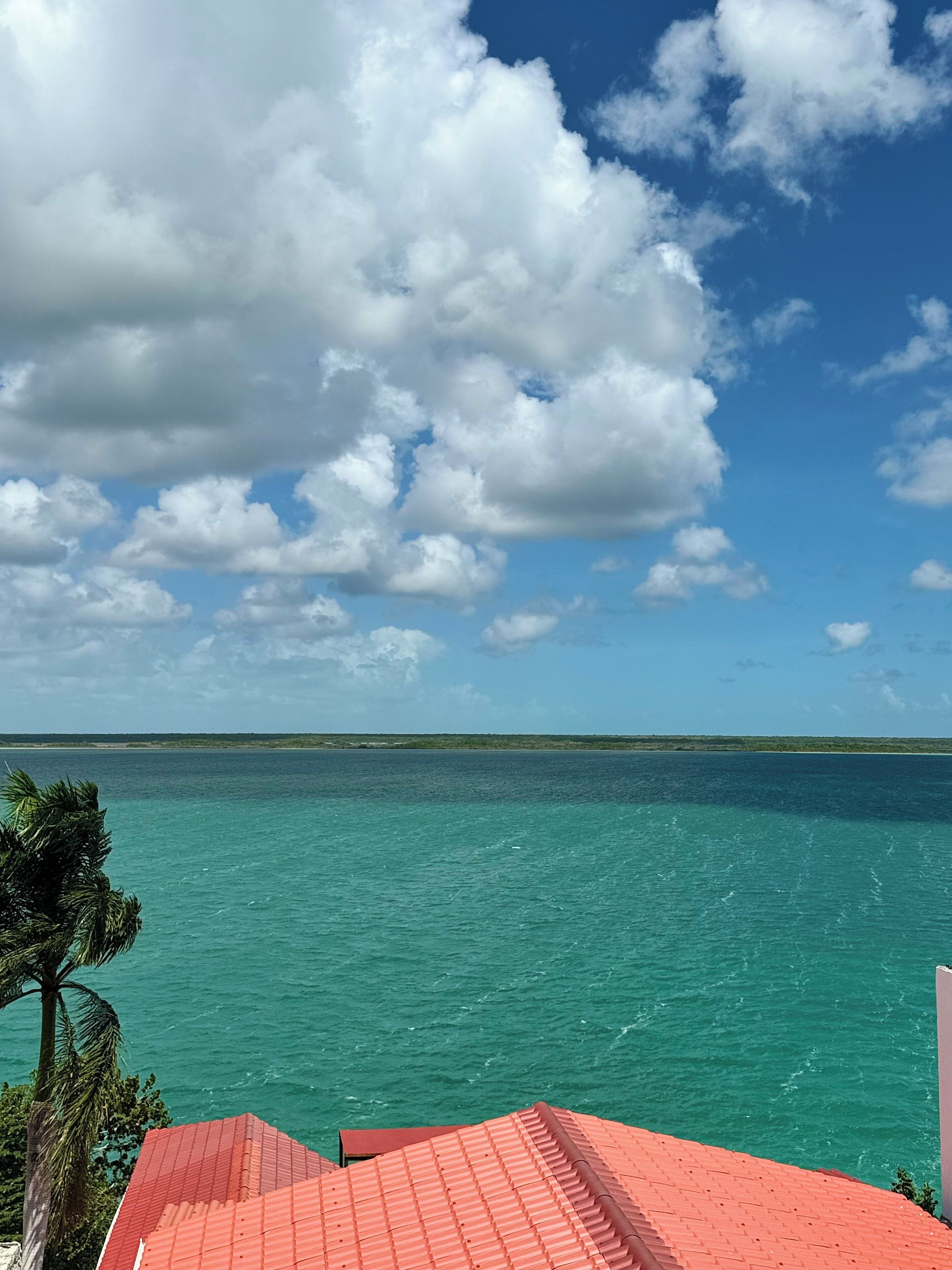 A coastal view with a clear sky and turquoise sea.