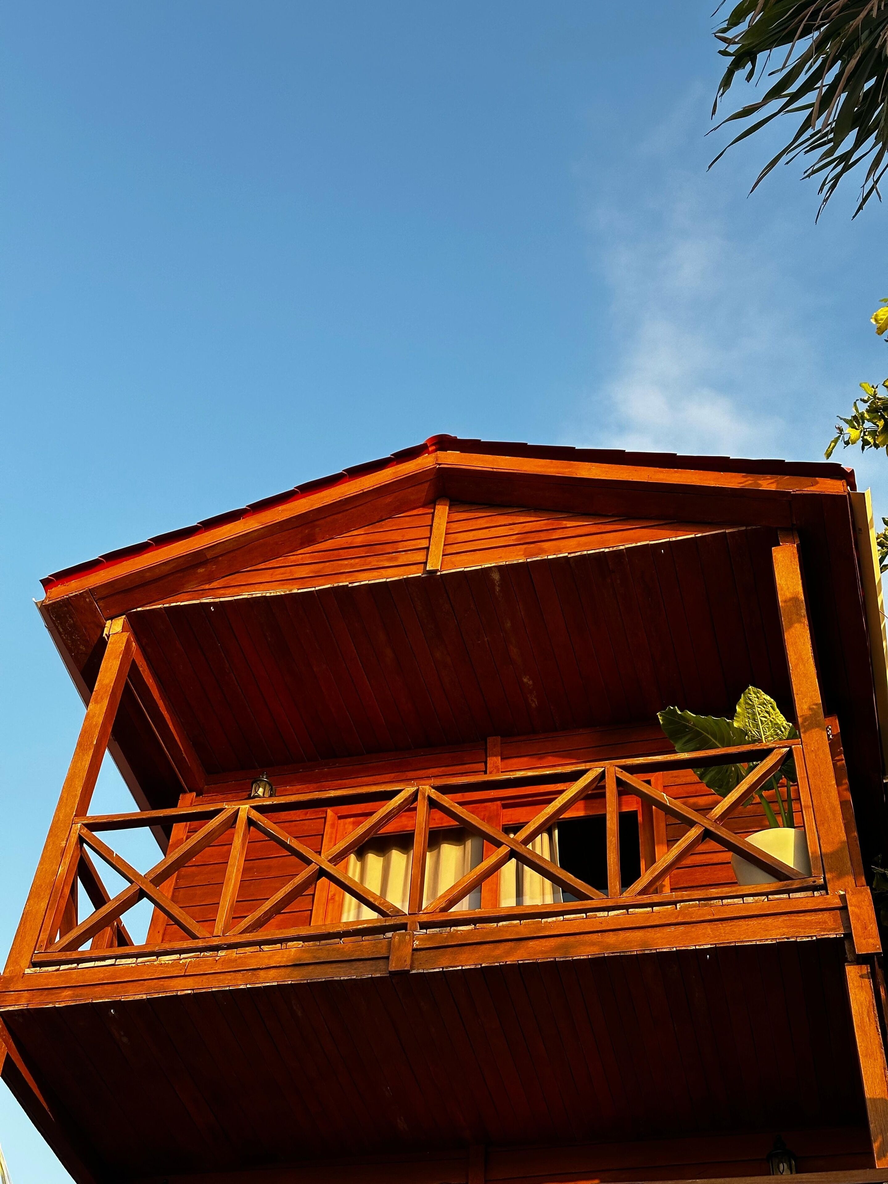 A wooden observation tower with a balcony, offering a clear view of the surrounding area.