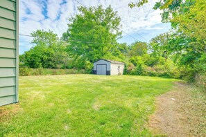 Escape to a serene retreat surrounded by lush trees and a well-manicured lawn.