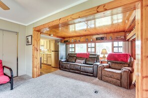 Relax in this inviting living room with a leather sofa set, armchair, and large window.