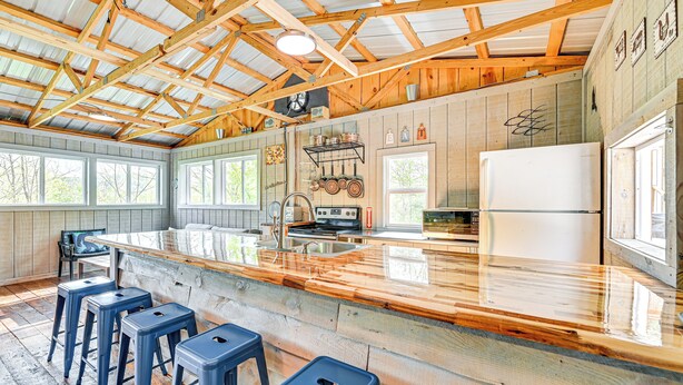 A spacious kitchen with a large island, wooden beams, and a rustic aesthetic. - Secluded on 10 Acres: Livingston Getaway w/ Sauna! (Livingston)