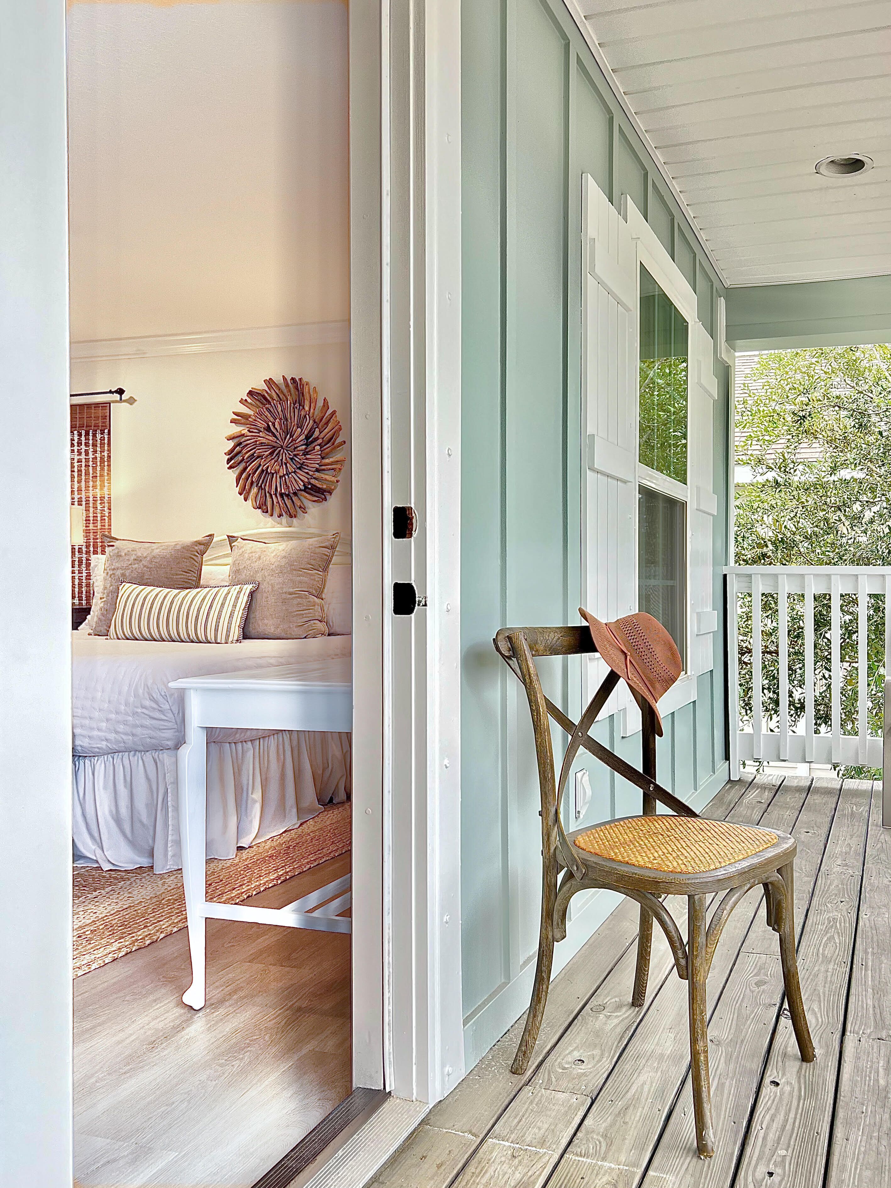 A bedroom with a bed, bedside table, and a decorative wall piece.