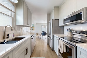 Enjoy cooking in this well-lit kitchen with ample counter space and modern appliances.