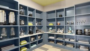 A kitchen with multiple shelves containing various kitchen appliances and utensils. - Landing Apartments Santa Rosa Beach (Santa Rosa Beach)