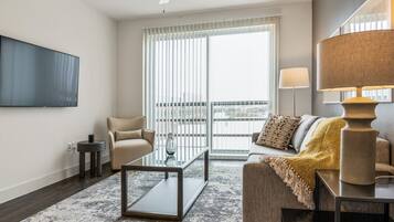 Apartment, 1 Bedroom | Living area | 50-inch TV with digital channels