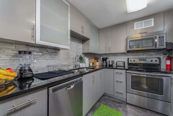 Enjoy cooking in this well-equipped kitchen with a microwave, oven, and dishwasher.
