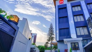 A modern hotel with a prominent 'Star' sign, a staircase leading to the entrance, and a clear sky. - Spree Hotel Kriday Dehradun (Dehradun)