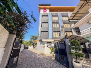 A hotel with a modern facade, a gated entrance, and a clear sky. - Spree Hotel Kriday Dehradun (Dehradun)