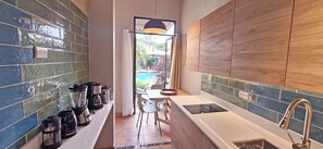 Classic Studio Suite, Pool View | Private kitchen | Fridge, microwave, stovetop, cookware/dishes/utensils