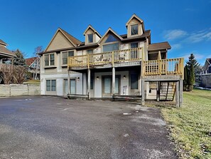 A two-story house with a balcony, garage, and a driveway. - Beautiful Day by Taylor Made Deep Creek (McHenry)