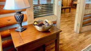 A wooden table with a lamp and a bowl of decorative items. - Mountain Getaway Cabin steps from Dwtn. W.P.: Hike, Bike, Fish & Enjoy 338570 (Woodland Park)