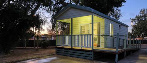 A small, single-story cabin with a porch and a covered entryway.
