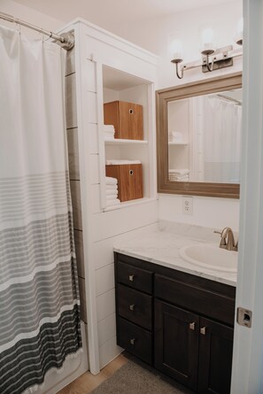 Enjoy a refreshing shower in this bathroom with a shower, vanity, and mirror.