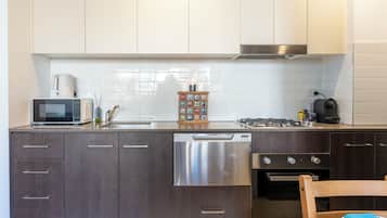 Enjoy cooking and dining in this well-equipped kitchen with a stove, microwave, and dishwasher.