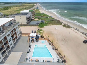A hotel with a rooftop pool, beach access, and ocean views. - Sunset Over the Dunes by Carolina Getaway - Oceanfront POOL & HOT TUB OPEN (Carolina Beach)