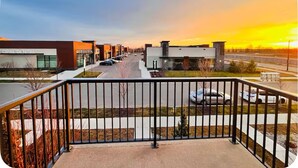 A modern dental clinic with a parking lot and a view of the sunset. - Luxury 3 Bedroom Home | Fireplace | 84” Pool Table| Air Conditioning| Garage (Edmonton)