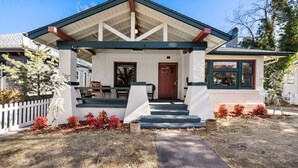 A single-story building with a covered porch, a front door, and a small window. - The American Dream: Historic S Mt Vernon Craftsman (Prescott)