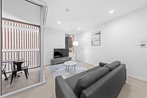 One Bedroom Apartment | Living area | 28-inch TV with satellite channels