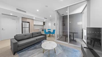 One Bedroom Apartment | Living area | 28-inch TV with satellite channels