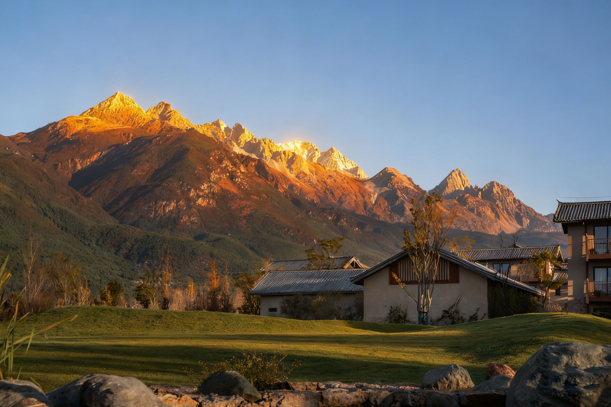 A mountain landscape with a house featuring a traditional roof and a modern building with a balcony.