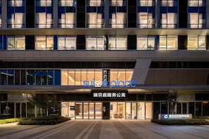A modern hotel with a prominent signage reading "suisse place".