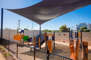 Kids can play and climb in the outdoor play area with a variety of structures and slides.