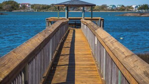 A wooden pier leading to a gazebo over water. - Pelican Nest by Topsail Realty (Sneads Ferry)