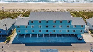 A multi-story hotel with a flat roof, located near a beach with ocean views. - Coral Surf #A1 - Beachy Keen by Carolina Retreats (Carolina Beach)