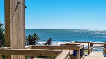 A wooden deck with a view of the ocean.