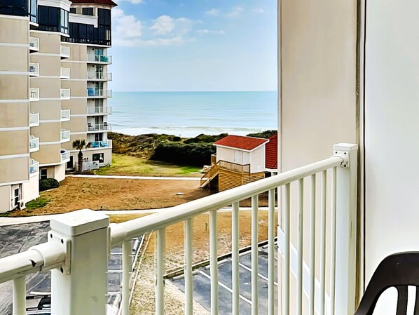 A balcony with a view of a beach and ocean. - St. Regis by Carolina Retreats (Sneads Ferry)