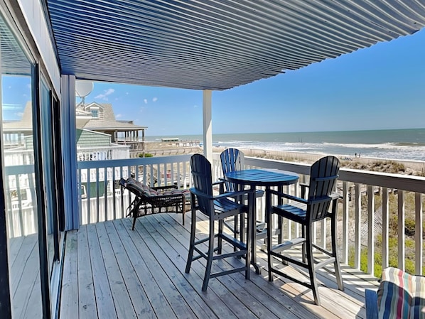 Enjoy ocean views from this deck with two chairs and a table.