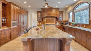 A spacious kitchen with a large island, wooden cabinets, and a built-in oven. - Cozy Edwards Retreat w/ Fireplace, Near Ski Resort Osprey Nest by Avantstay (Edwards)