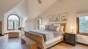 A bedroom with a large bed, a bench, a nightstand, and a window with a view of trees. - Cozy Edwards Retreat w/ Fireplace, Near Ski Resort Osprey Nest by Avantstay (Edwards)