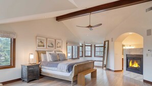 A spacious bedroom with a large bed, a wooden bench, a nightstand, and a fireplace. - Cozy Edwards Retreat w/ Fireplace, Near Ski Resort Osprey Nest by Avantstay (Edwards)