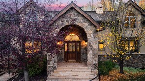A stone house with a wooden entrance, a stone archway, and a staircase leading to the door. - Cozy Edwards Retreat w/ Fireplace, Near Ski Resort Osprey Nest by Avantstay (Edwards)