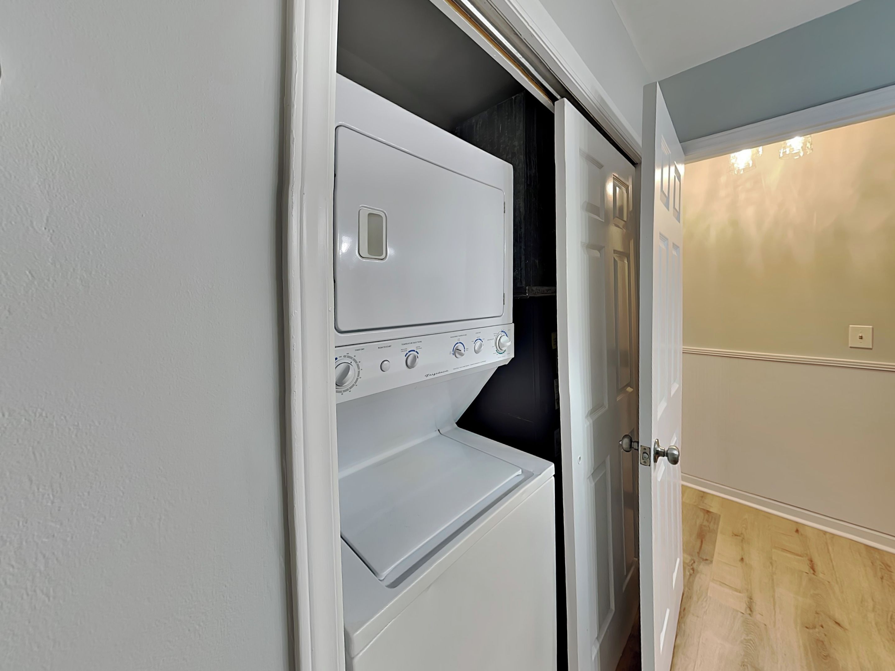 A laundry room with a white dryer and a white washing machine.
