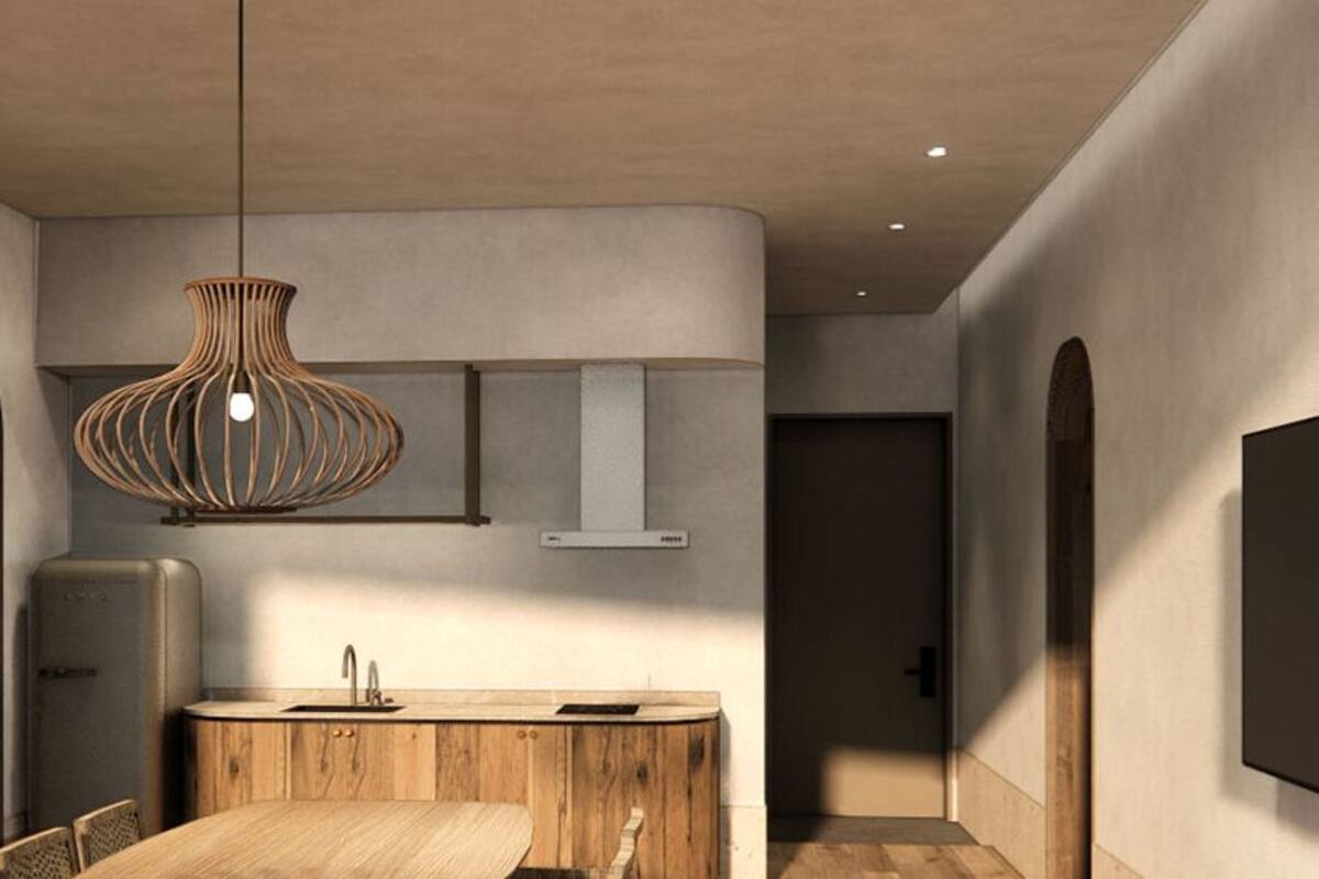 A modern kitchen with a wooden dining table, a hanging pendant light, and a built-in oven.