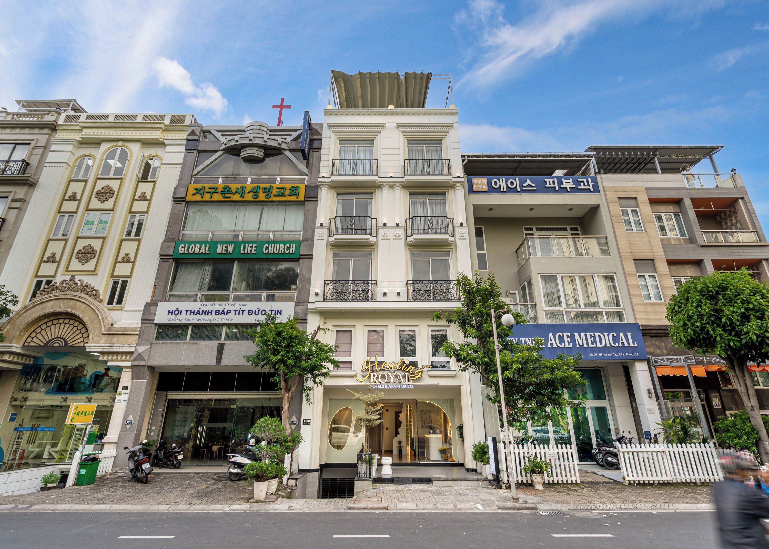 A multi-story building with various businesses including a church, a medical facility, and a hotel.