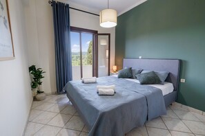 A bedroom with a bed, a potted plant, a view through a window, and a ceiling light. - Apartment 'Breathing' with Mountain View, Wi-Fi, and Air Conditioning (Virós)
