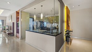 A modern hotel lobby with a glass partition, a reception desk, and a potted plant. - Corinna by Kozystay - Senayan (Jakarta)