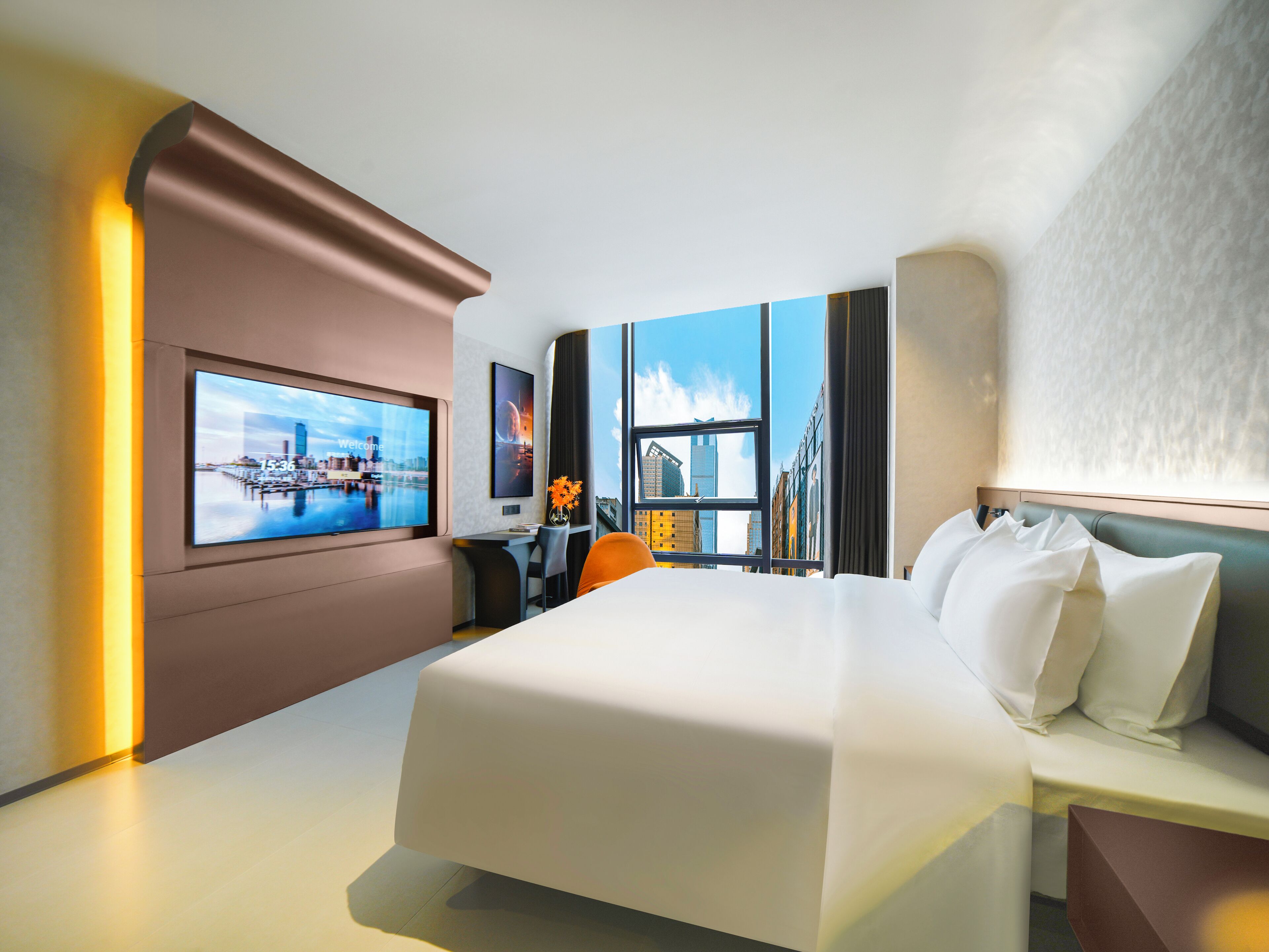 Ein modernes Hotelzimmer mit einem großen Bett, einem Schreibtisch mit Stuhl, einem Flachbildfernseher und Blick auf die Stadt durch das Fenster.