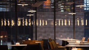 A modern restaurant interior with tables and chairs arranged for dining. - chongqinglangxidujiajiudian (Deyang)