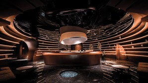 A modern, circular spa area with a central hot tub, ambient lighting, and marble flooring. - chongqinglangxidujiajiudian (Deyang)