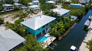 A coastal residential area with houses, a swimming pool, and a marina.