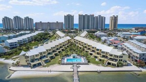 A resort with multiple buildings, a central pool, and a beach view. - Peaceful Paradise - Boat Slip, Pool & Beach Access (Navarre)