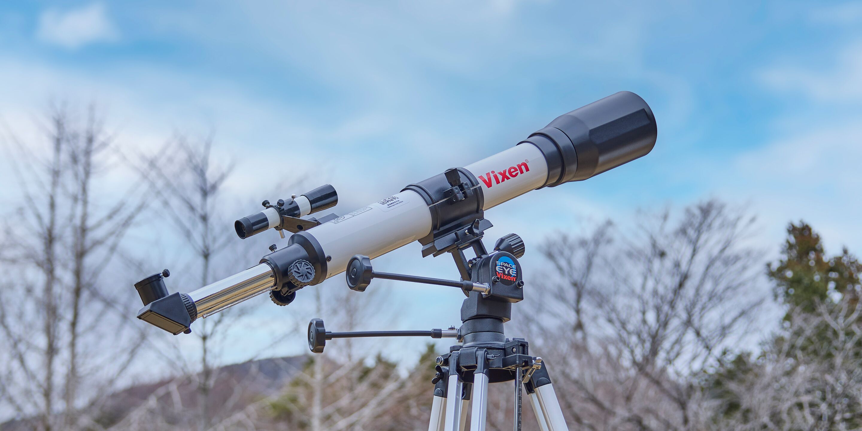 A Vixen telescope mounted on a tripod.